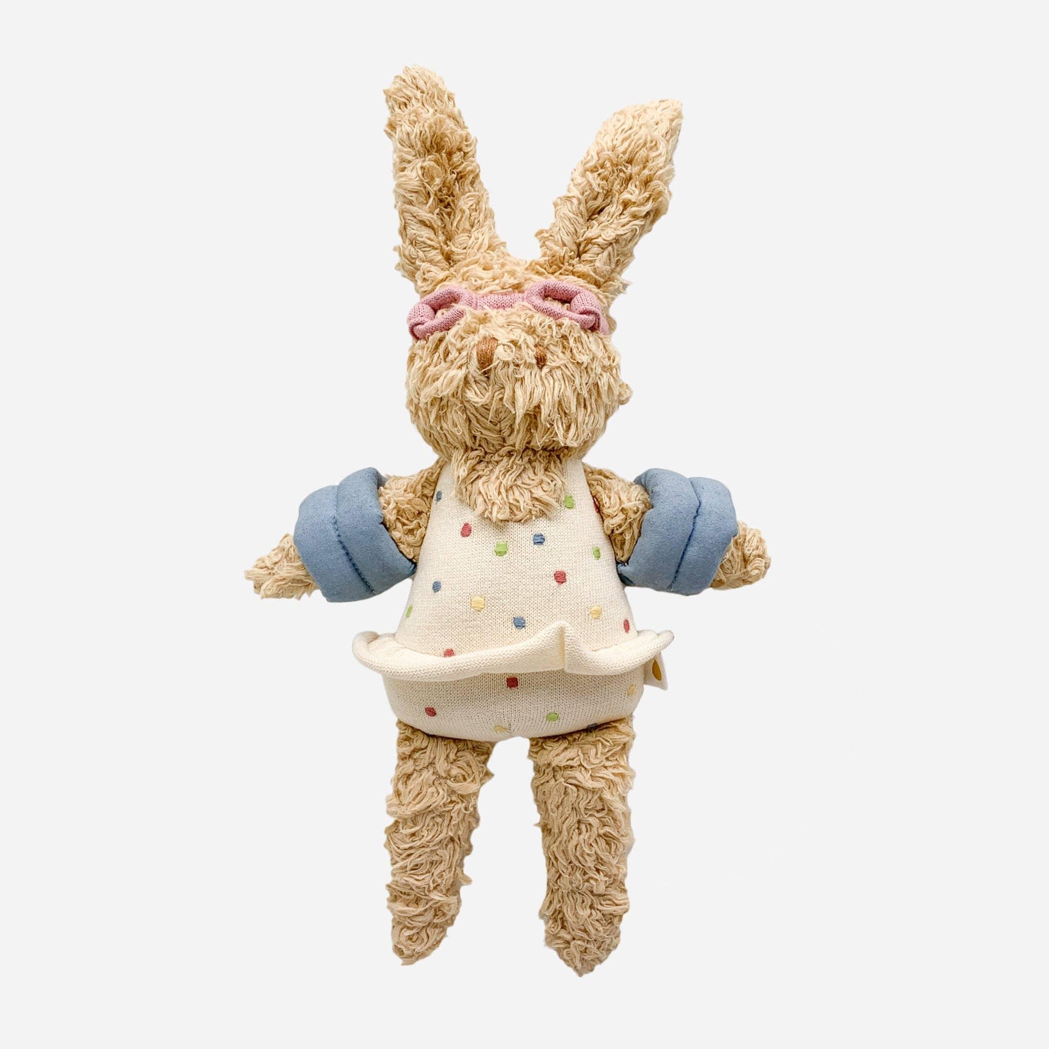 Soft curly-haired bunny plush in polka dot dress with blue sleeves and pink bow, perfect for kids' playtime