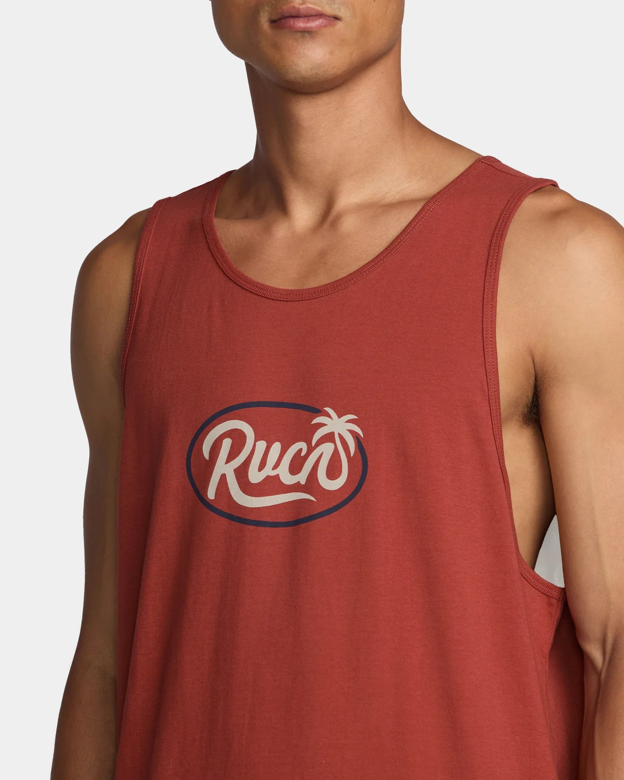 Rust-colored Ruck tank top with palm tree logo, perfect for coastal adventures and outdoor lifestyle.