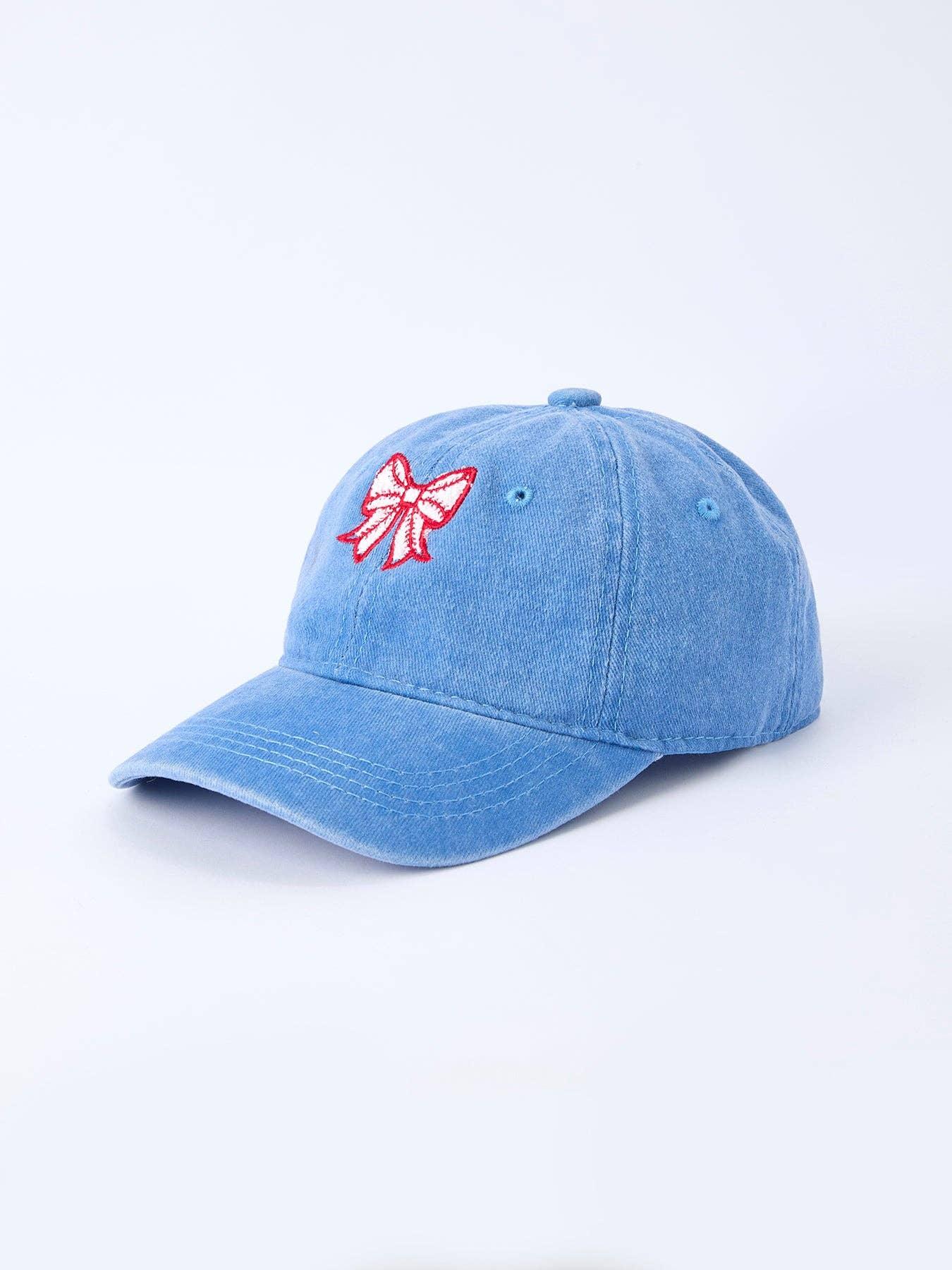 Light blue dad hat with red and white embroidered bow, casual coastal style accessory