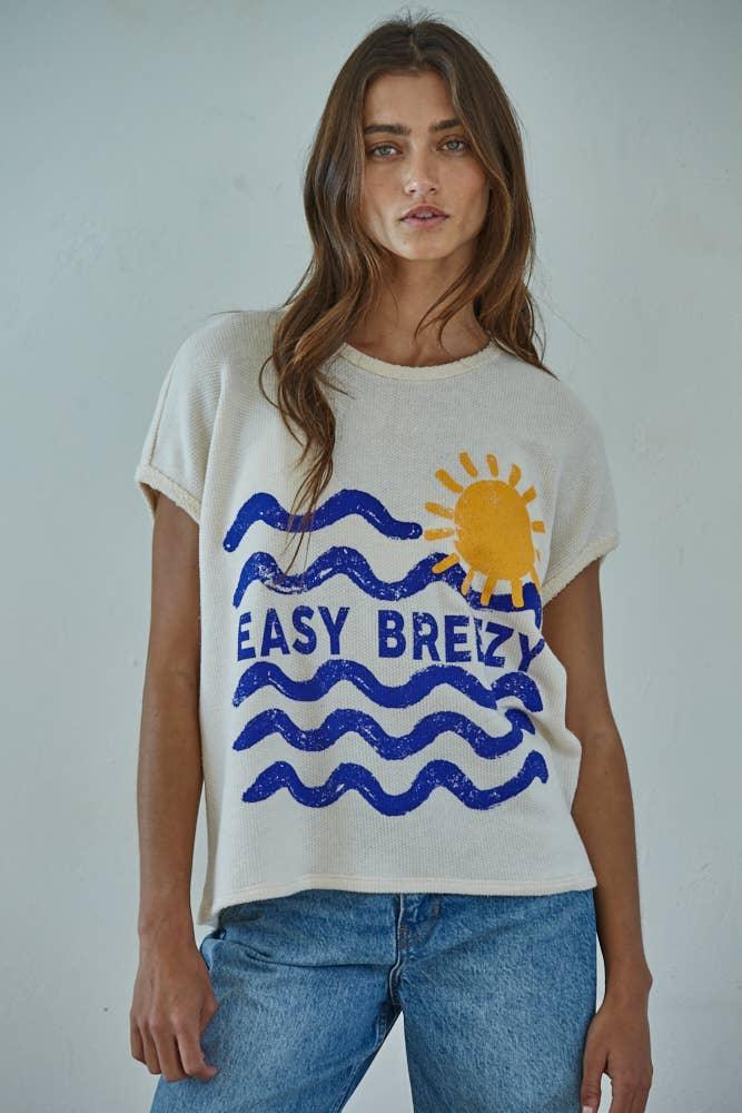 Cream knit tee with 'Easy Brezy' ocean waves and sun graphic, coastal style for beach days and PNW adventures