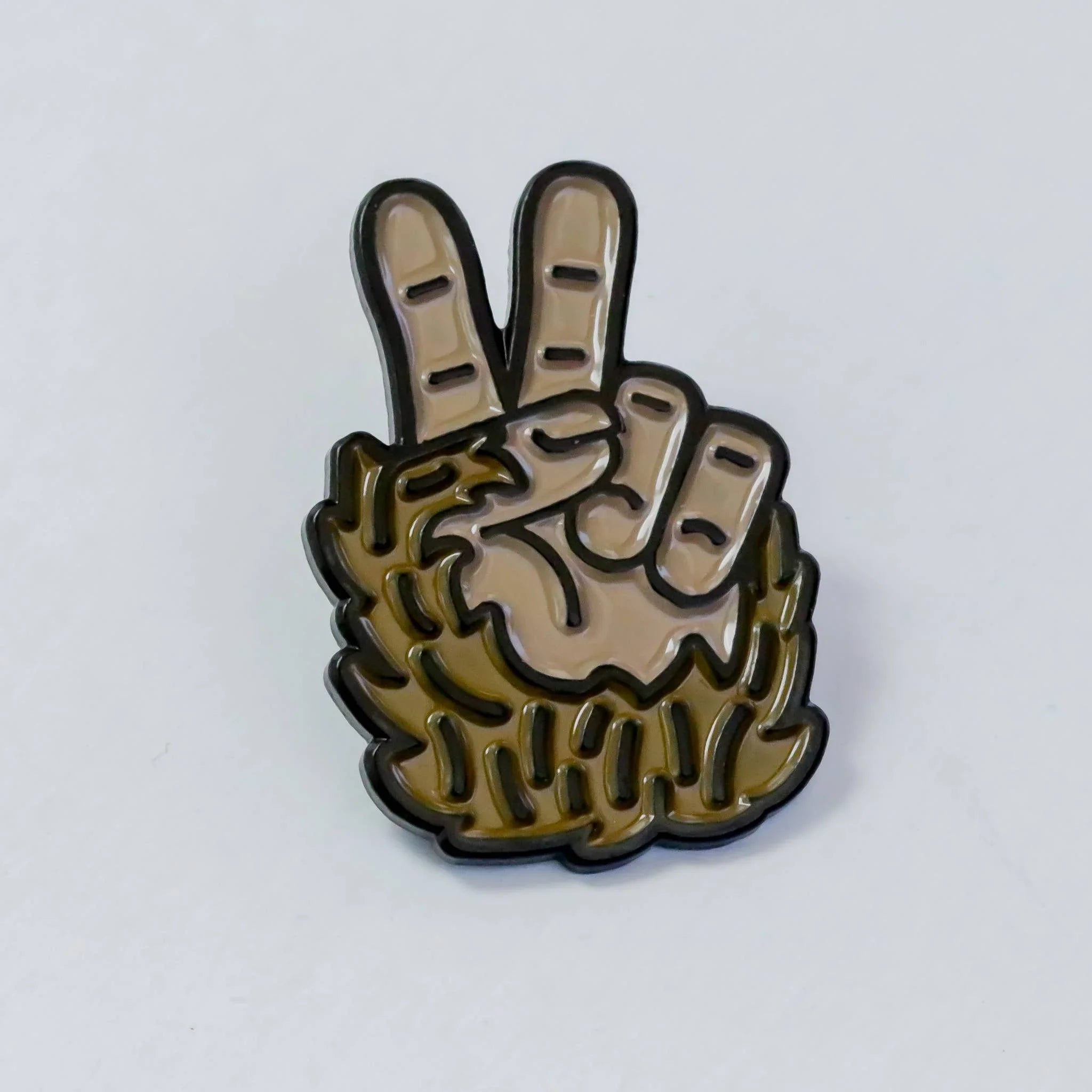 Peace sign hand enamel pin with detailed finger lines and bold outline design