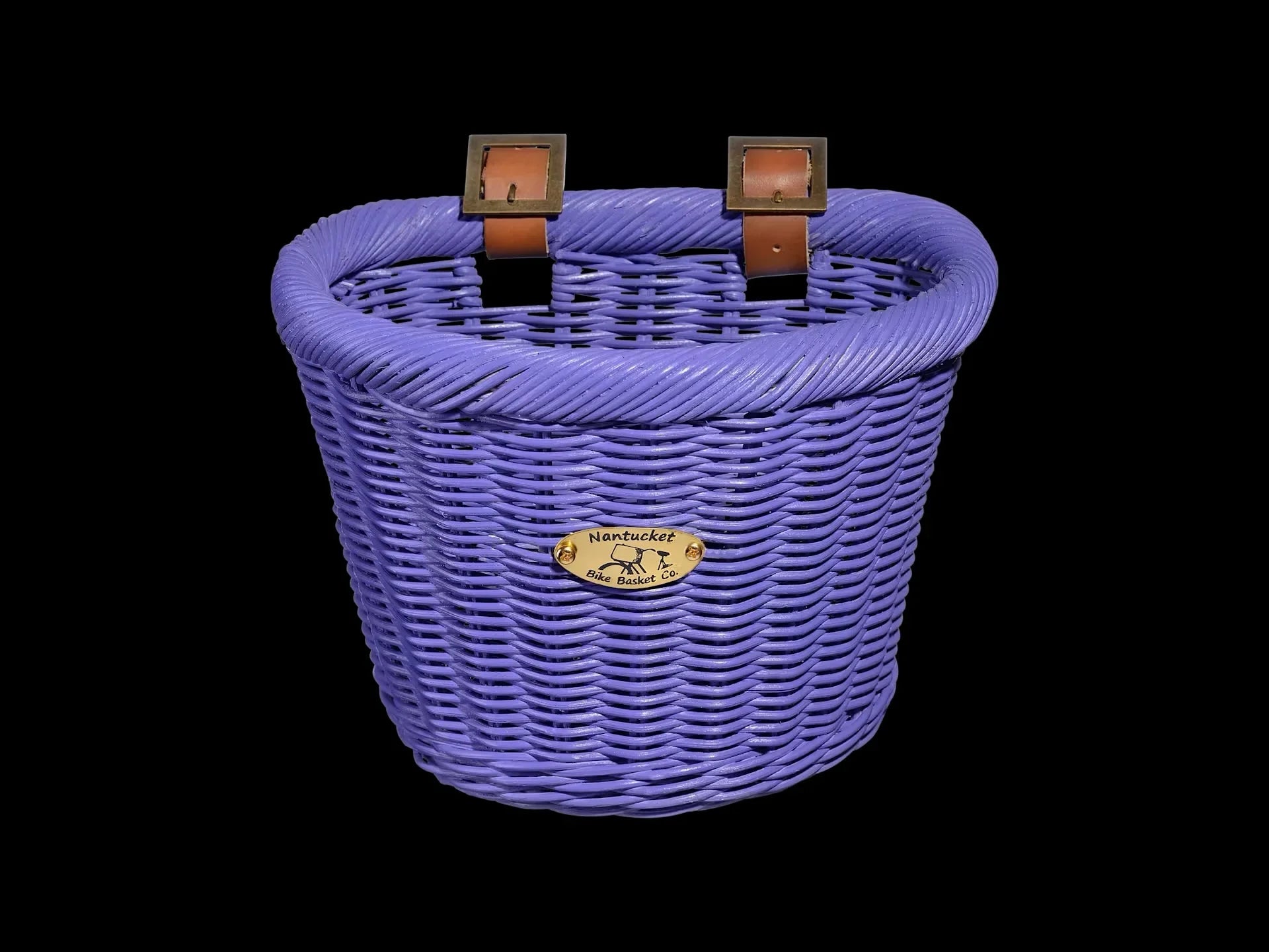 Purple woven bike basket with leather straps and Nantucket Bike Basket Co. plaque, perfect for coastal adventures.