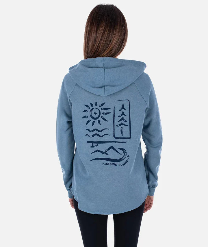 Women's blue hoodie with 'Chasing Sunsets' graphic, sun, waves, mountains, and tree design for outdoor adventures