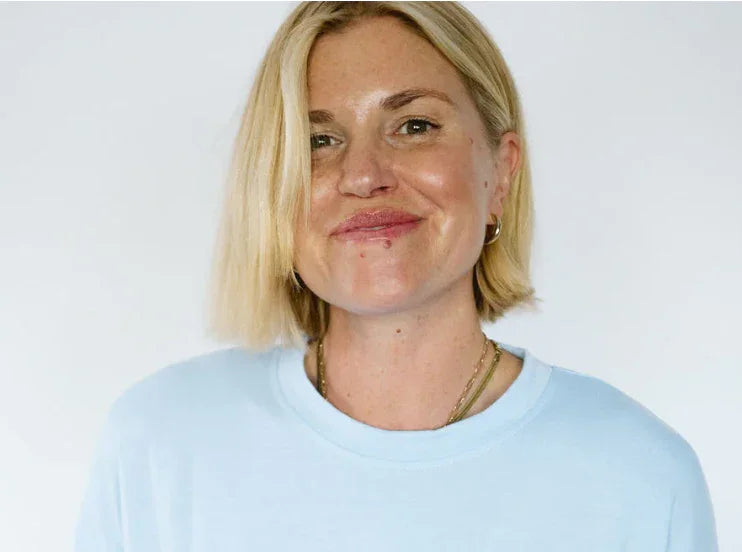 Woman in light blue crewneck tee, coastal style for PNW adventures