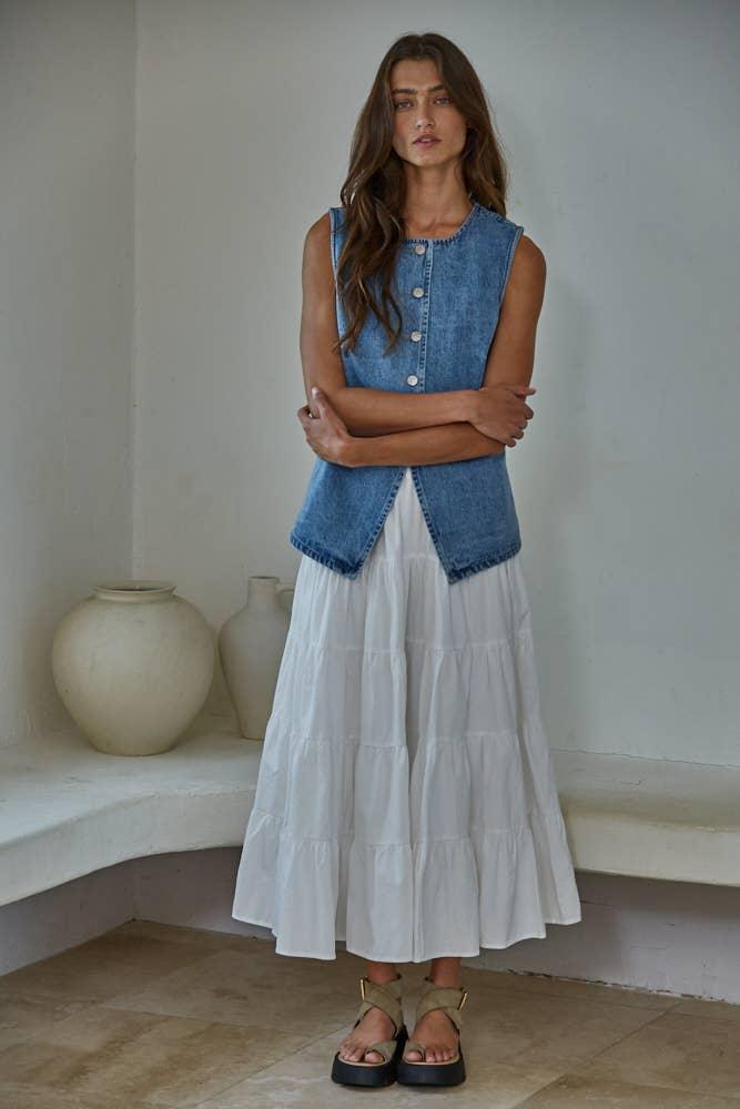 Woman in denim vest and white tiered skirt, coastal style outfit for beach days and PNW adventures