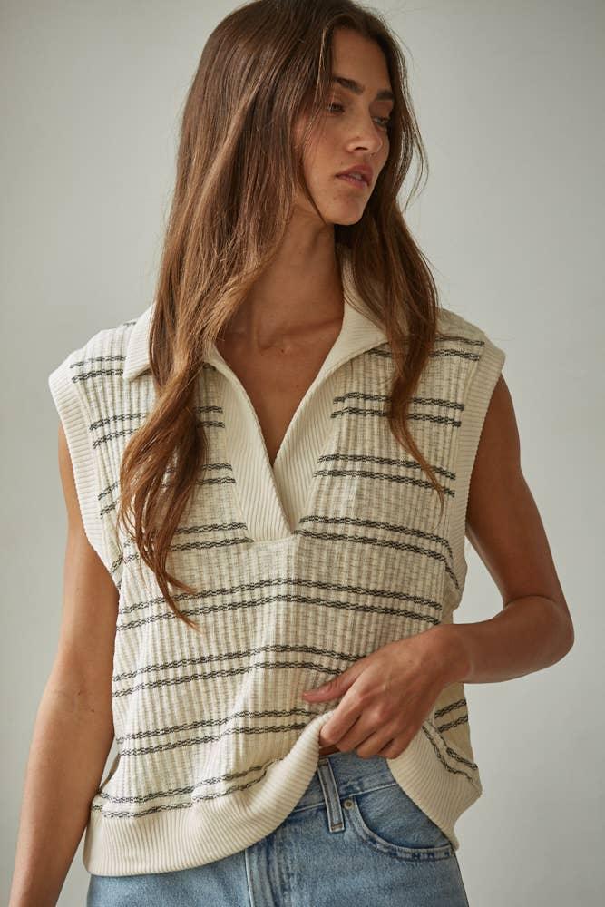 Cream striped sleeveless knit vest with collar, paired with denim jeans for coastal PNW style