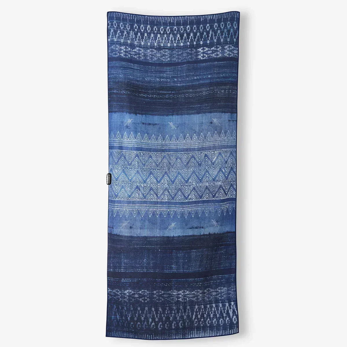 Blue patterned beach towel with geometric designs, perfect for coastal adventures and outdoor lifestyle