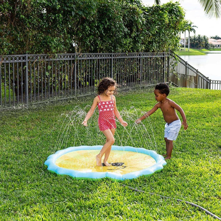 Kids playing on sunny day with inflatable splash pad in backyard, perfect for outdoor summer fun and lawn games.
