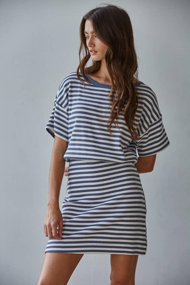 Woman in navy and white striped ribbed t-shirt dress, coastal style outfit for beach days or casual weekends
