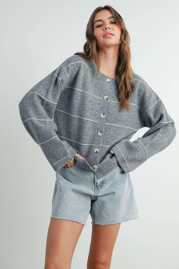 Grey striped button-up cardigan with light denim shorts, coastal casual style