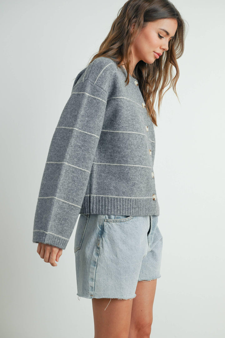 Gray striped button-up cardigan with light denim shorts, coastal style outfit