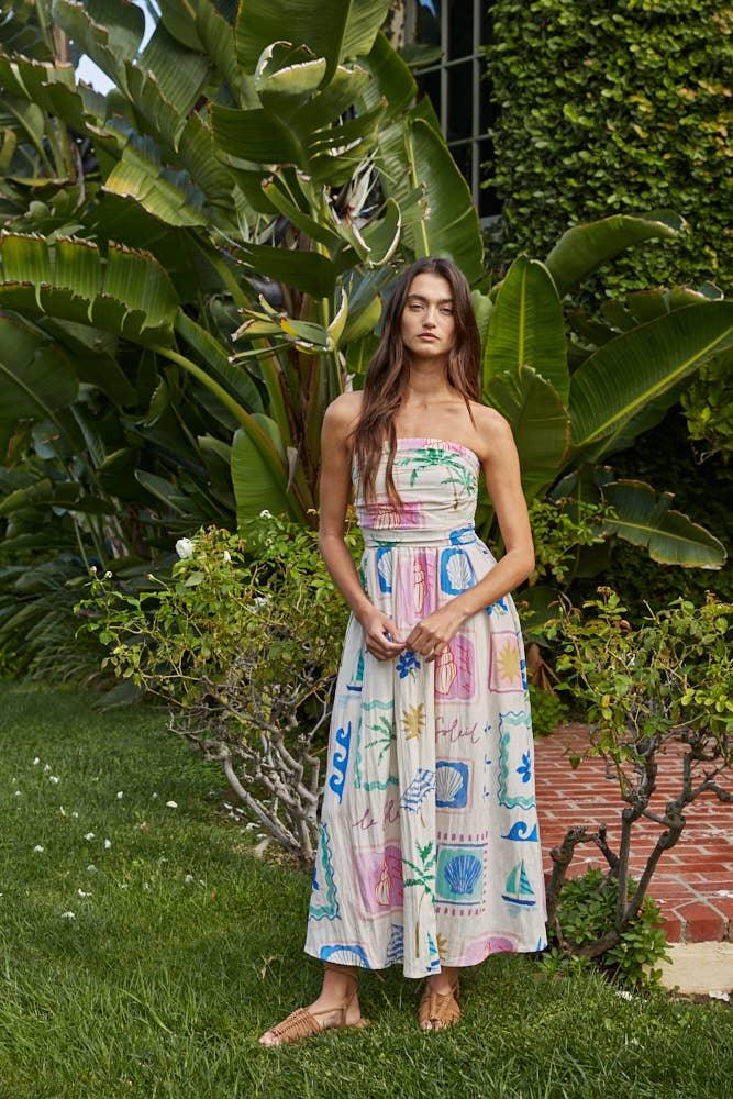 Woman in colorful coastal print strapless maxi dress, perfect for beach days and PNW adventures
