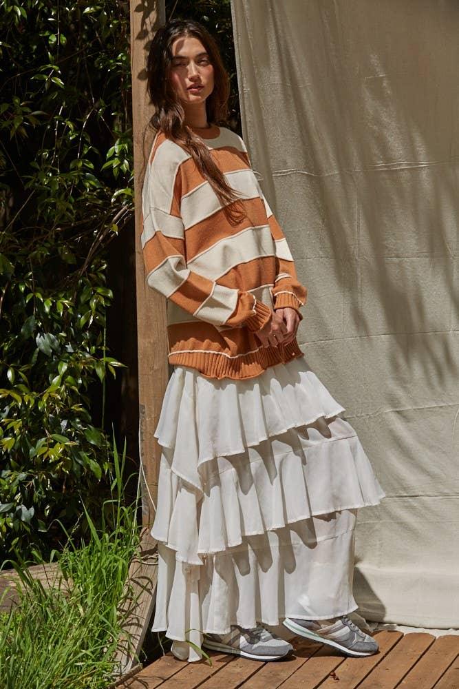 Woman in striped sweater and tiered skirt for coastal outdoor style