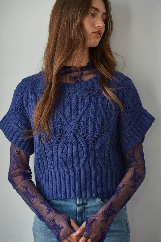 Blue cable knit sweater with sheer lace sleeves, styled for coastal PNW fashion