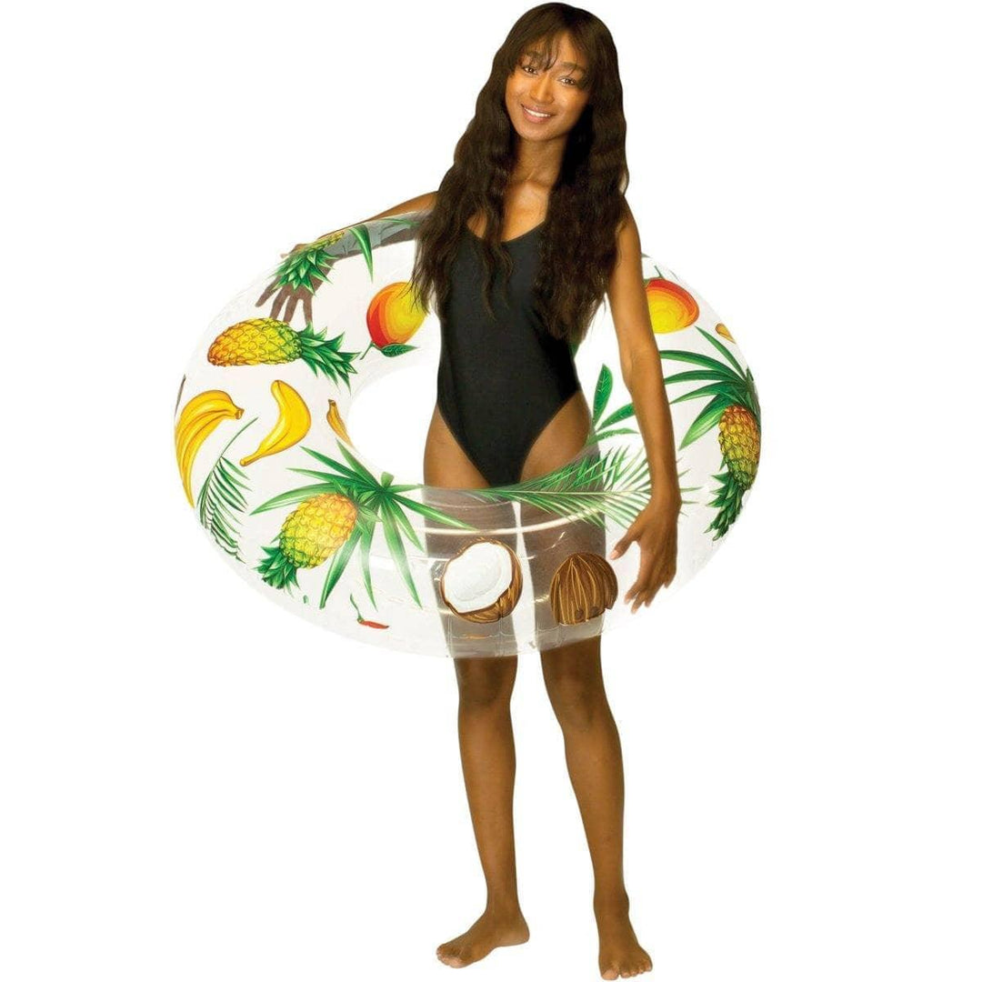 Woman in black swimsuit holding tropical fruit print inflatable pool float with pineapples, bananas, coconuts