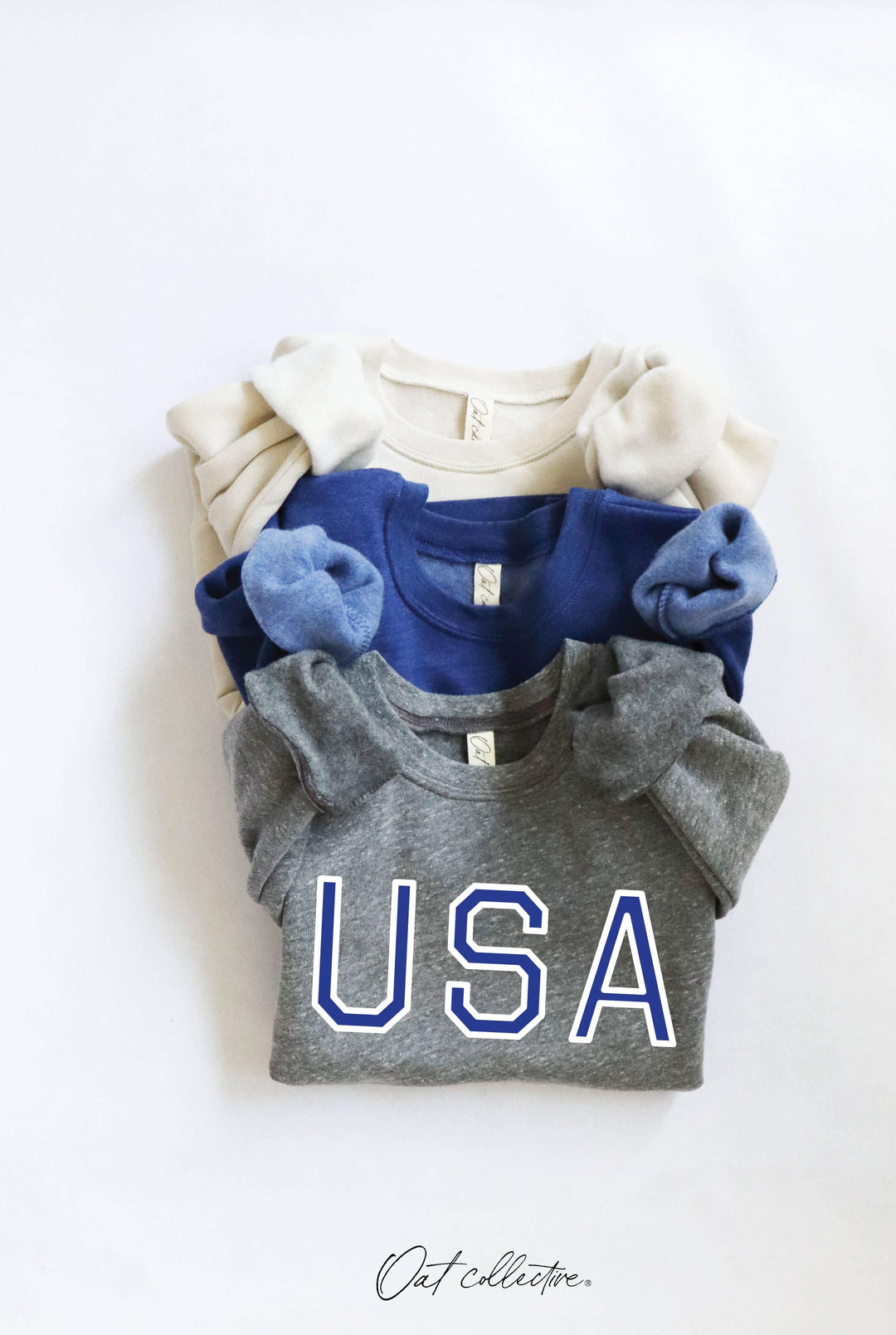 Stacked USA graphic tees in gray, blue, and cream for coastal PNW style