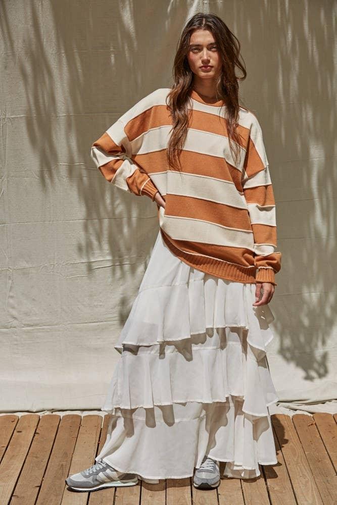 Striped orange and cream sweater with tiered white skirt, styled for coastal PNW outdoor adventures