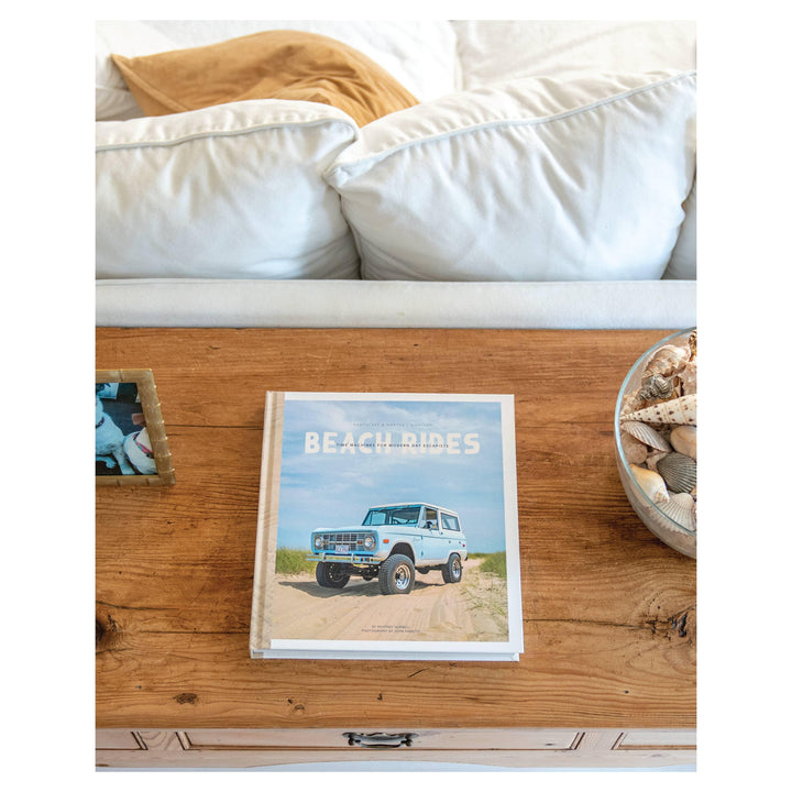 Beach Rides book on wooden table with seashells and coastal decor, perfect for PNW beach days and escapes