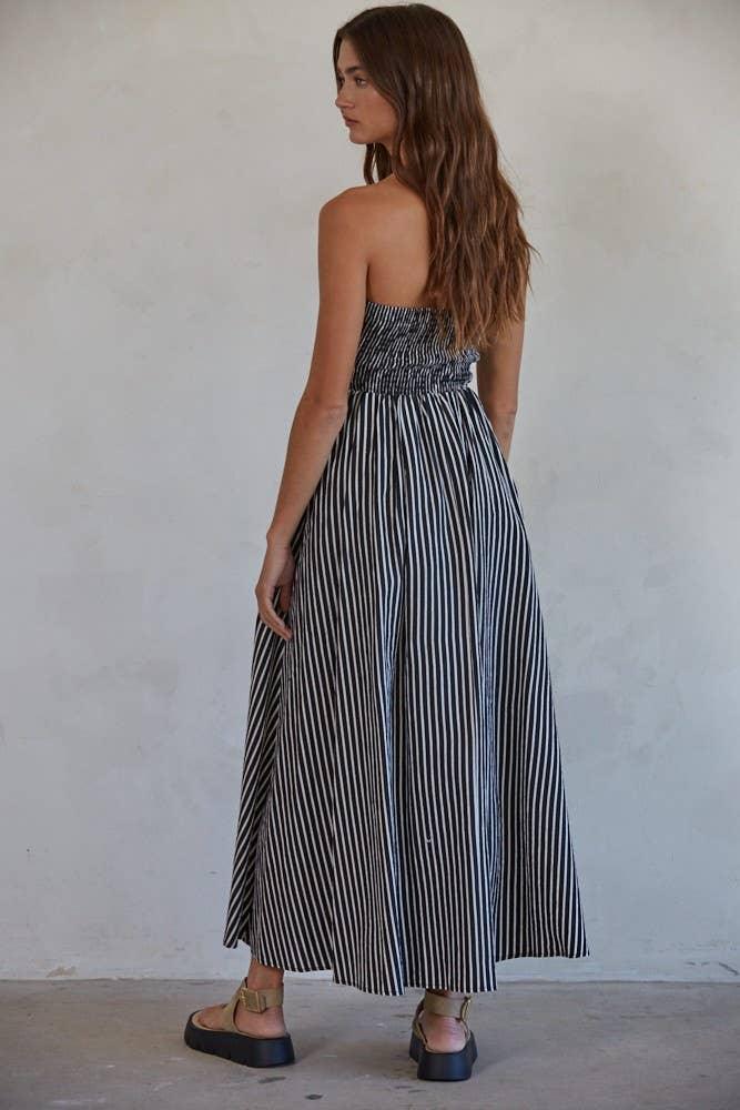 Woman in black and white striped strapless maxi dress with platform sandals, coastal style