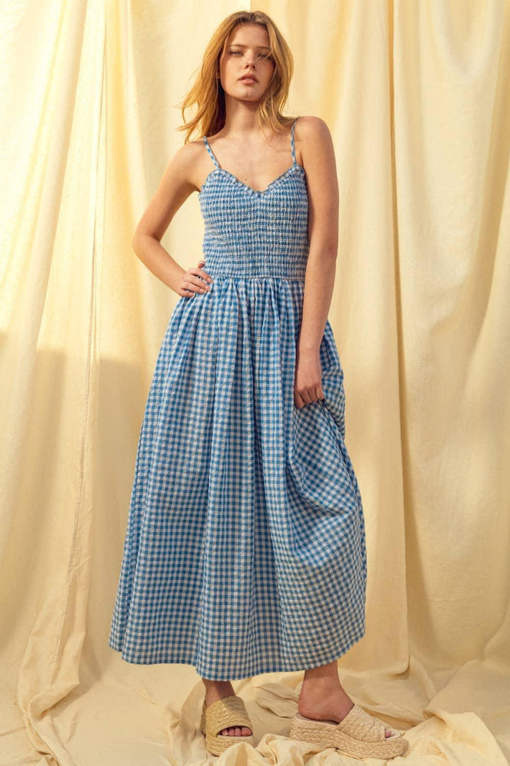 Blue gingham maxi dress with smocked bodice and spaghetti straps, paired with espadrille sandals