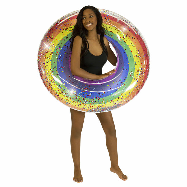 Woman holding rainbow glitter inflatable pool float for beach or lake fun