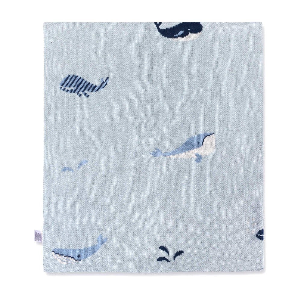 Light blue knit blanket with playful whale and fish patterns, soft texture for baby or nursery use