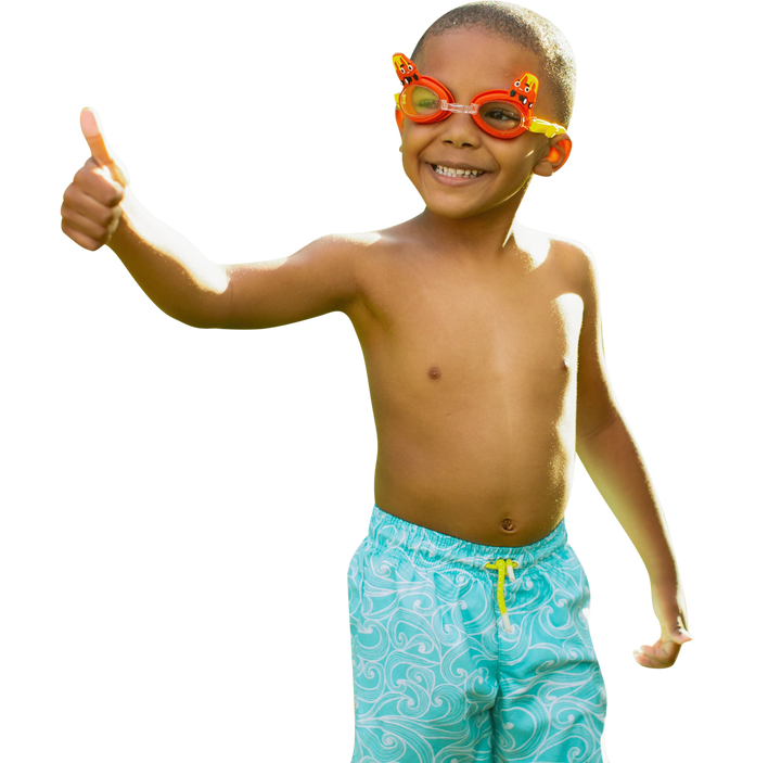 A smiling young boy wearing PoolCandy Little Tikes Cozy Coupe 3D swim goggles and blue swim trunks.