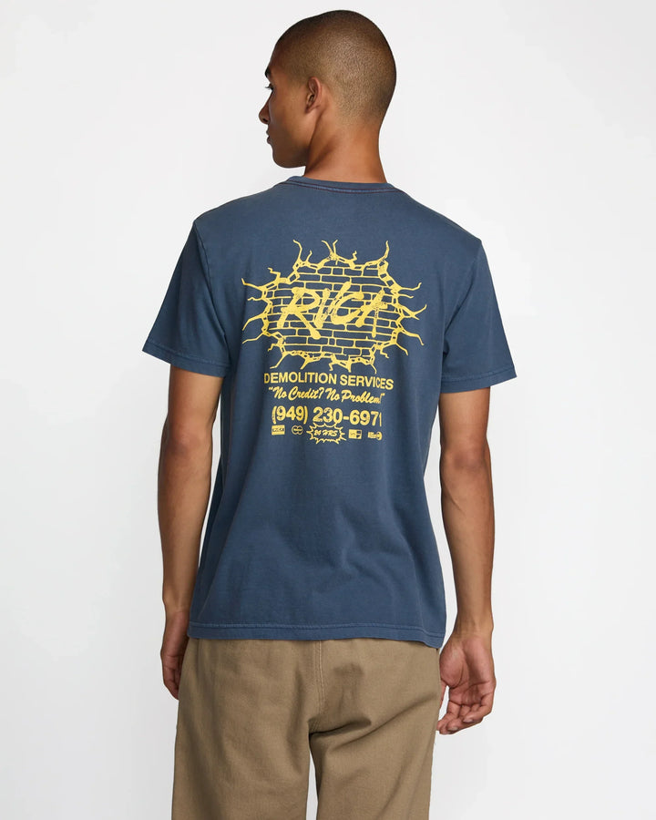 Man wearing blue graphic tee with yellow brick wall design, ideal for coastal PNW adventures and everyday style.