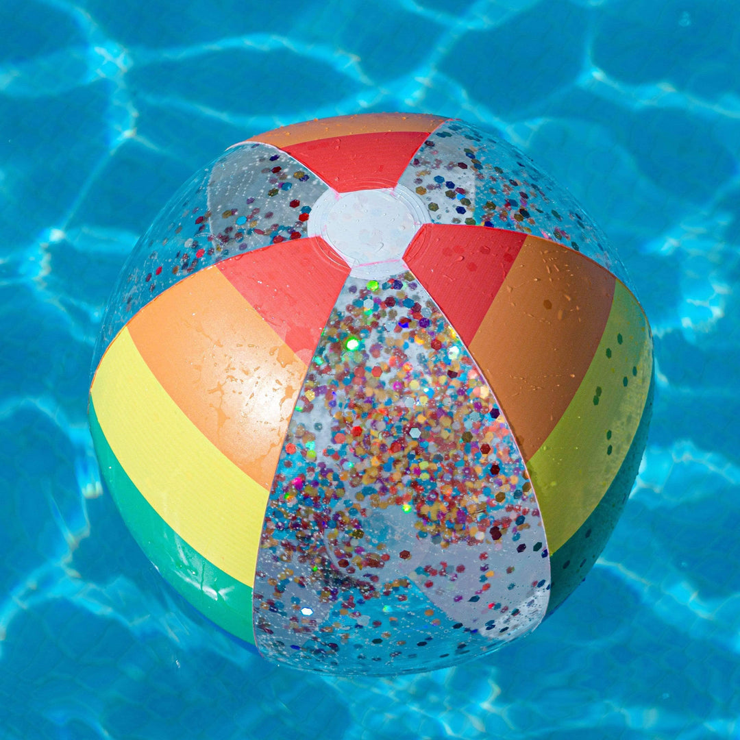 Colorful glitter beach ball floating in pool water, perfect for summer fun and outdoor adventures.