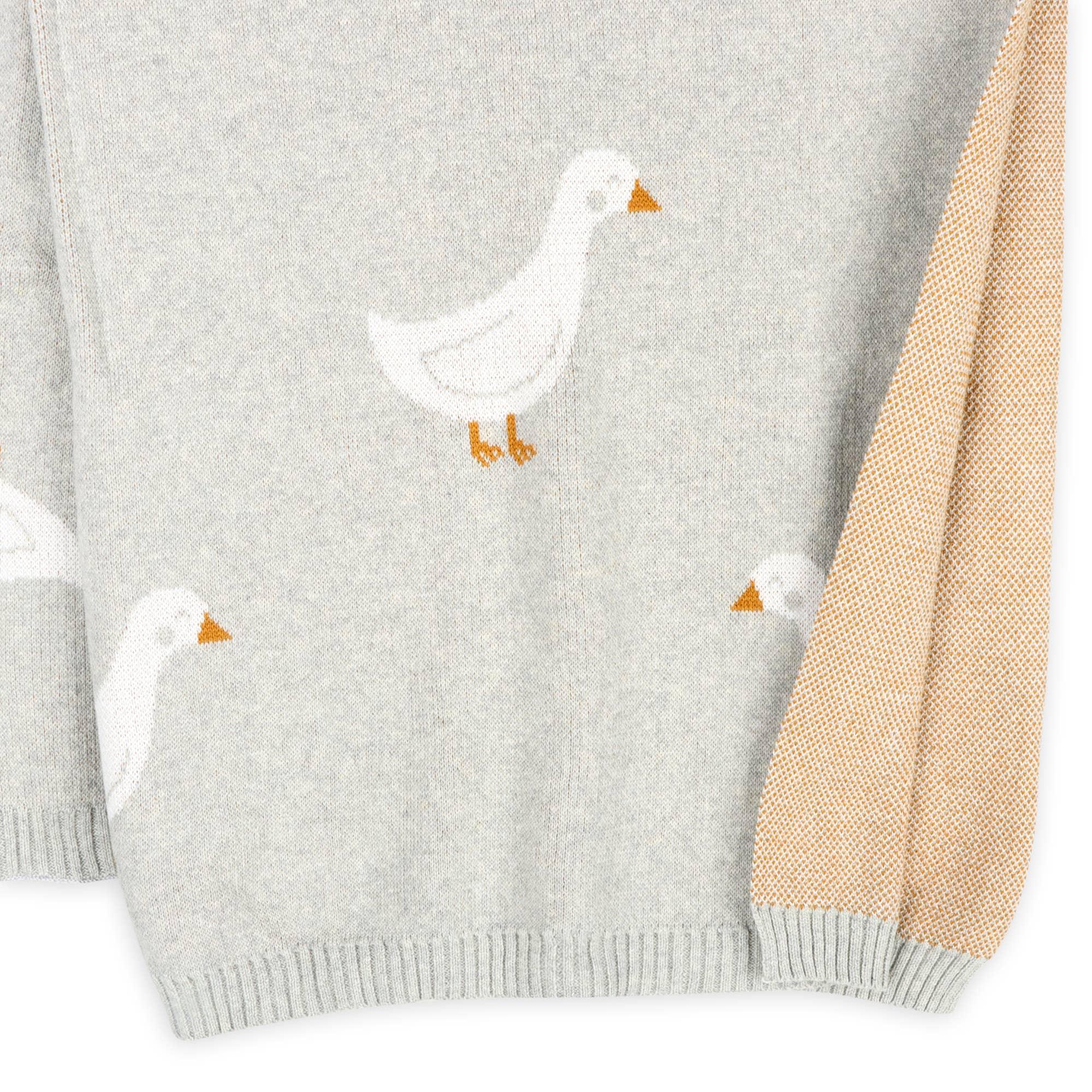 Gray knit sweater with white duck print and mustard yellow sleeve detail