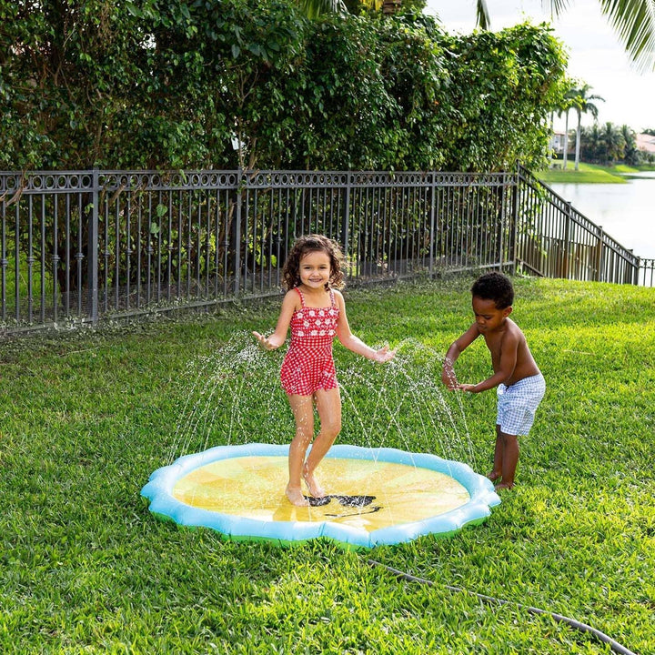 Kids playing on sunny day splash pad in backyard, outdoor summer fun for families