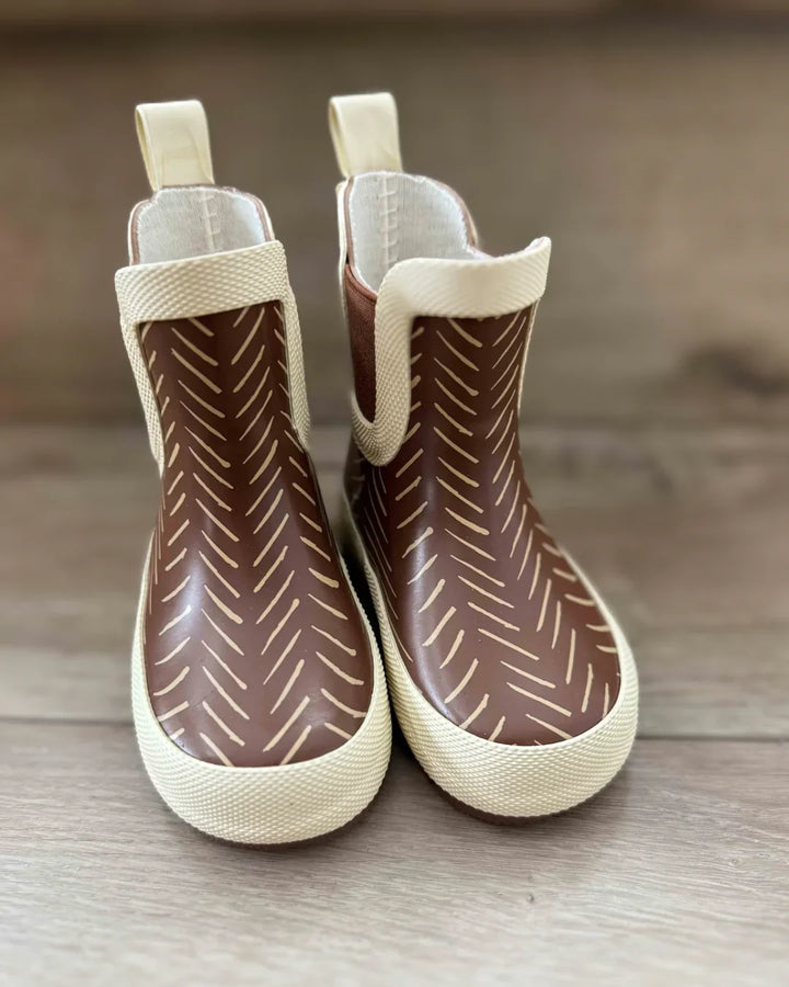 Brown rain boots with cream herringbone pattern, perfect for PNW adventures and coastal weather.