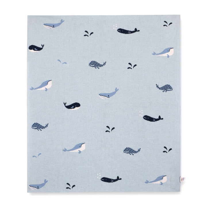 Light blue blanket with playful whale and splash patterns, ideal for baby nurseries or ocean-themed decor.