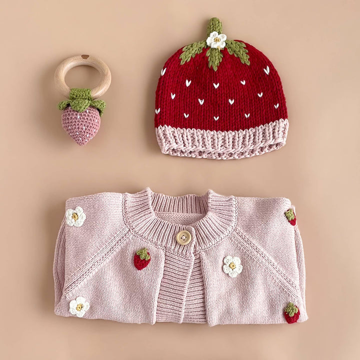 Strawberry-themed baby set: knit hat, cardigan, and teether toy with floral details