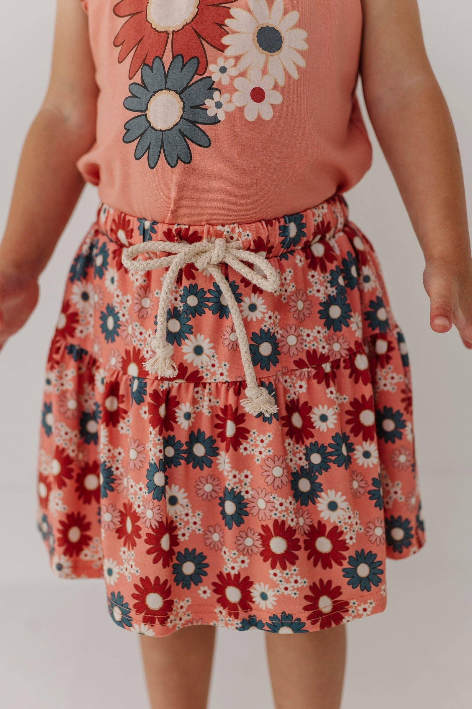 Child in coral floral tank top and matching tiered shorts with rope drawstring, perfect for beach days and outdoor adventures.
