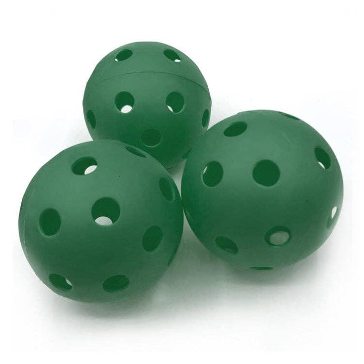 Three green perforated wiffle balls for outdoor play and backyard games