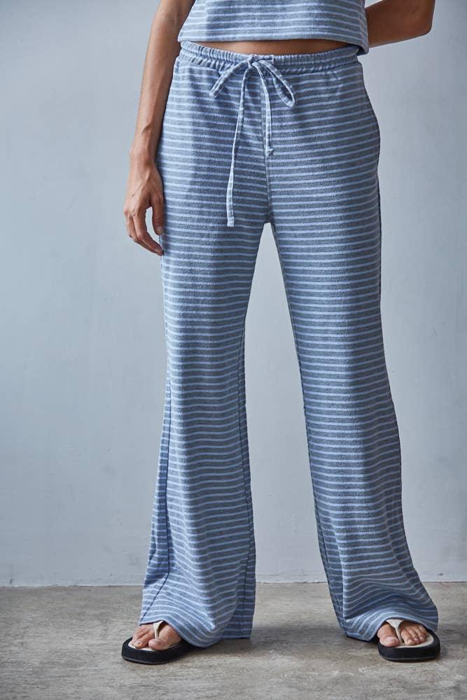 Blue striped wide-leg lounge pants with drawstring waist, paired with flip-flops for casual coastal style
