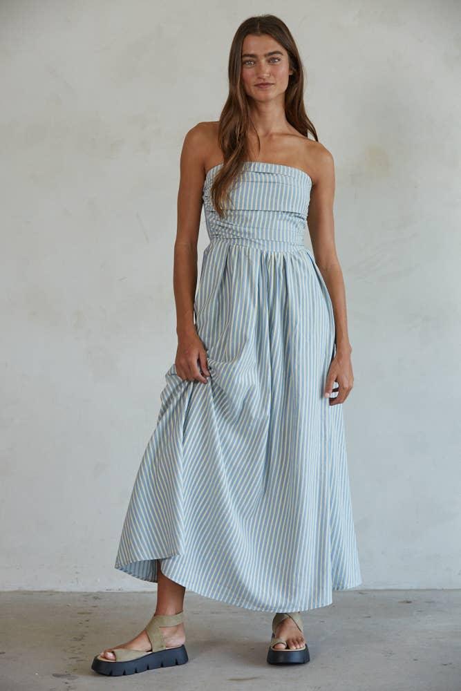 Woman in blue and white striped strapless maxi dress with platform sandals, coastal style outfit