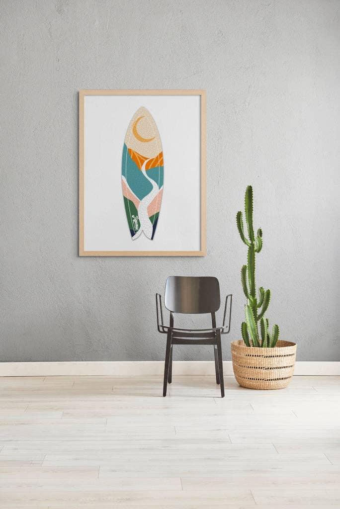 Colorful surfboard art print in wooden frame, modern decor with cactus and chair