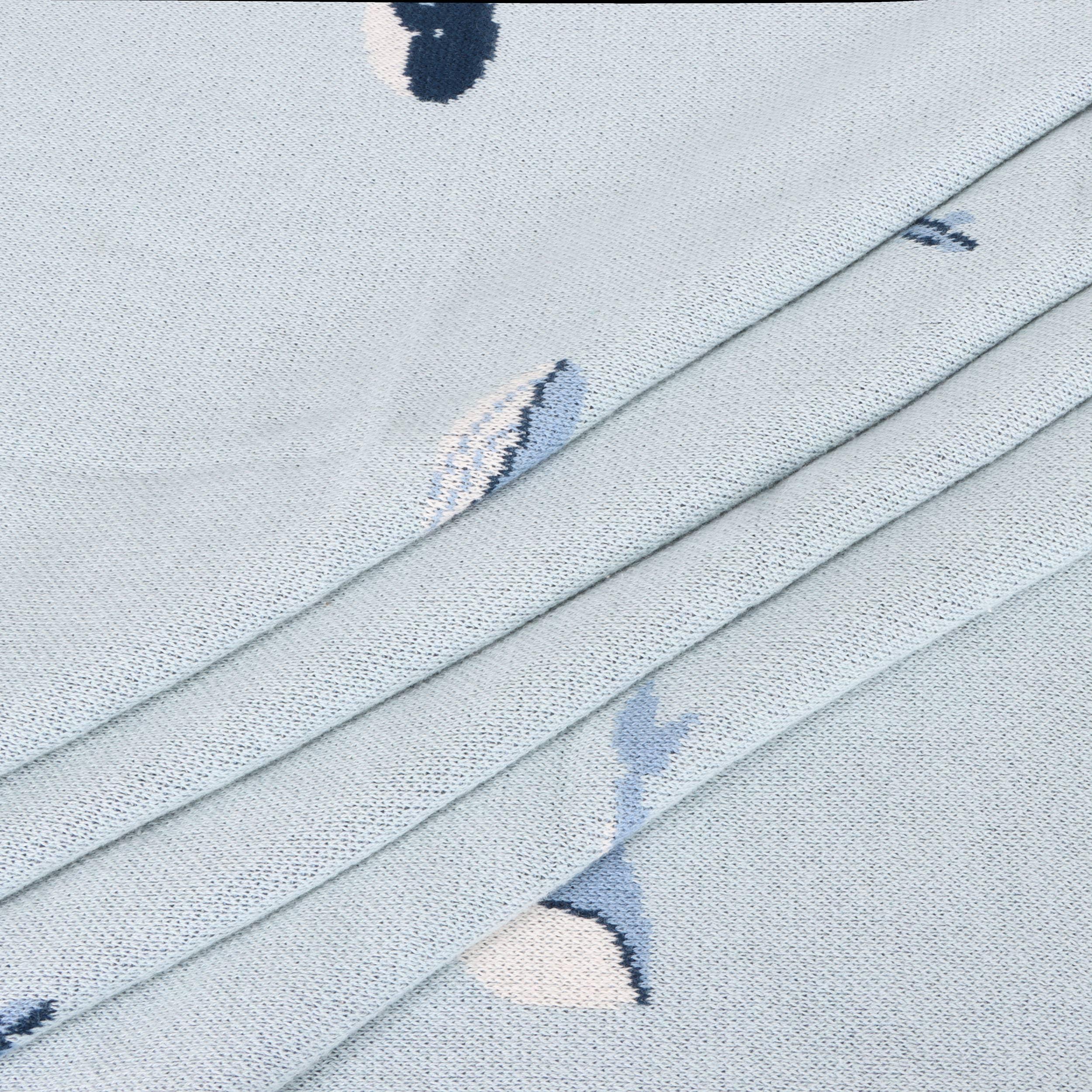 Light blue textured fabric with abstract navy and white patterns, ideal for outdoor gear and apparel.