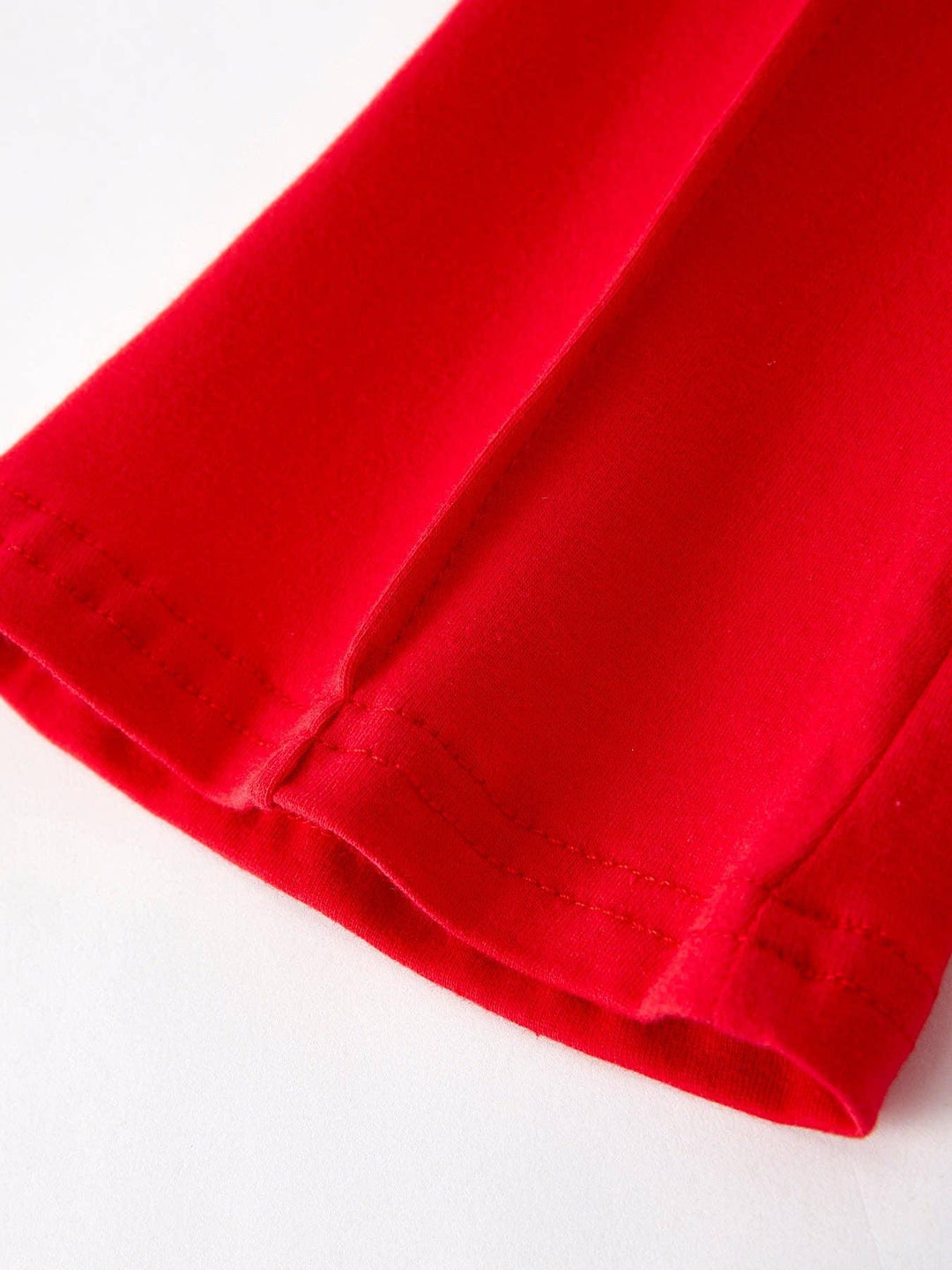 Vibrant red t-shirt hem with clean stitching, ideal for coastal adventures and everyday PNW style.