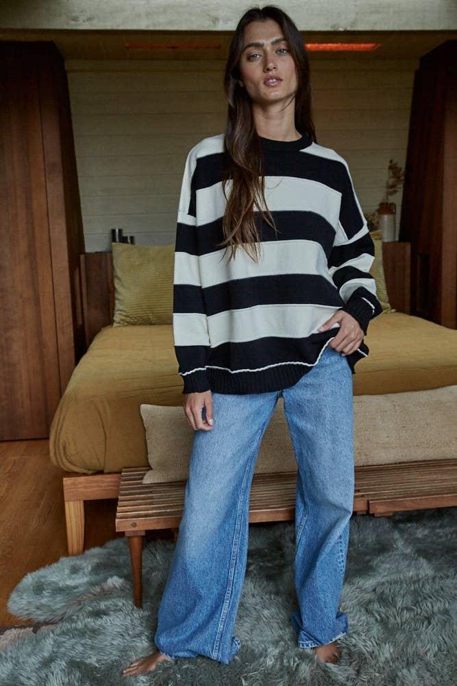 Woman in black and white striped sweater with wide-leg jeans, coastal home style