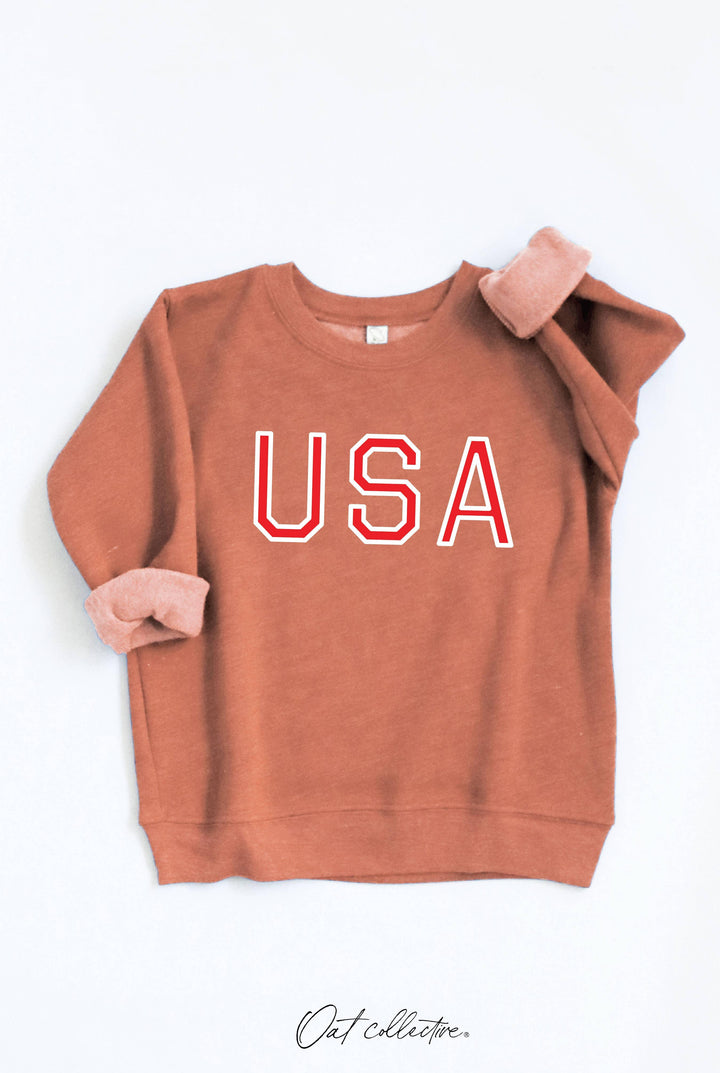 Rust-colored USA graphic sweatshirt with rolled sleeves, coastal PNW style