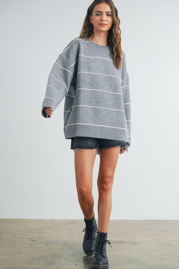 Gray striped oversized sweater with denim shorts and combat boots for coastal PNW style