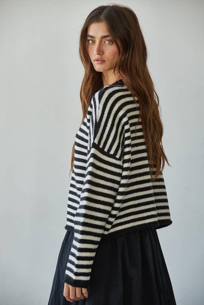 Woman in black and white striped cozy sweater, coastal style outfit