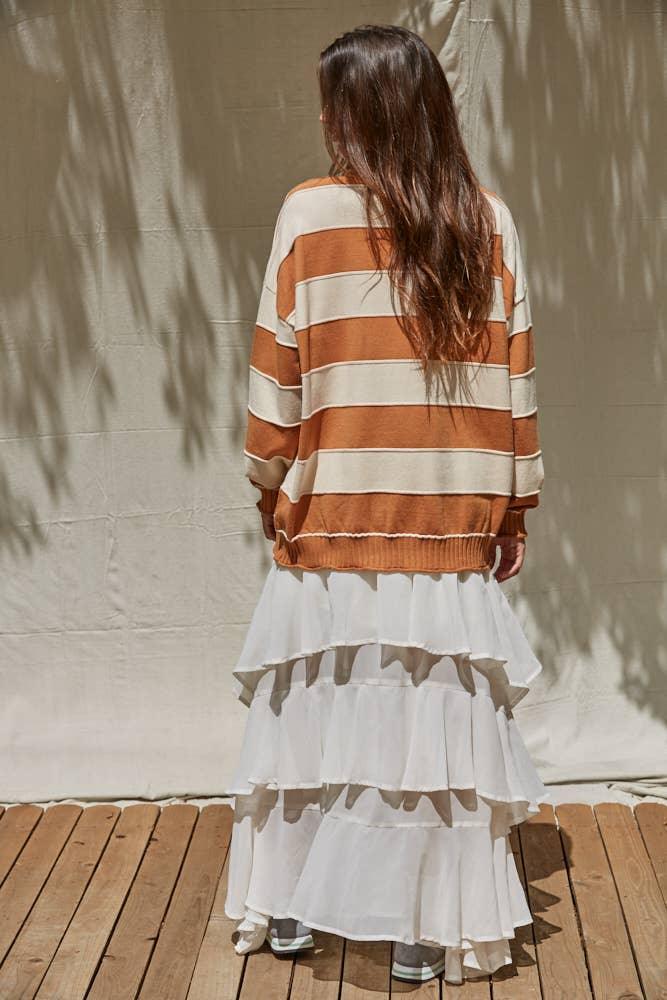 Striped orange and cream sweater with white ruffle skirt, coastal outdoor style