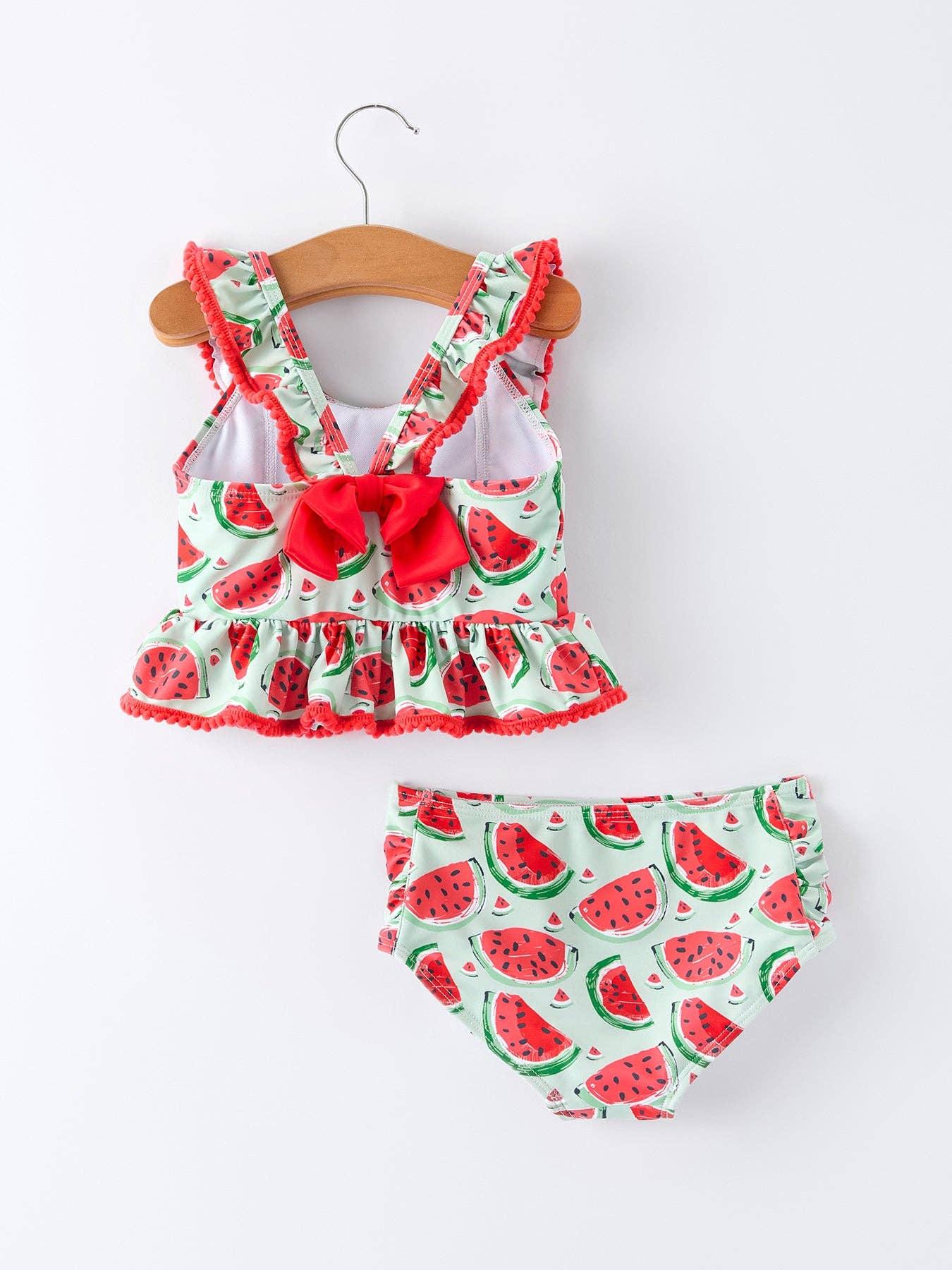 Watermelon print toddler swimsuit with ruffles and bow, perfect for beach days and summer adventures.