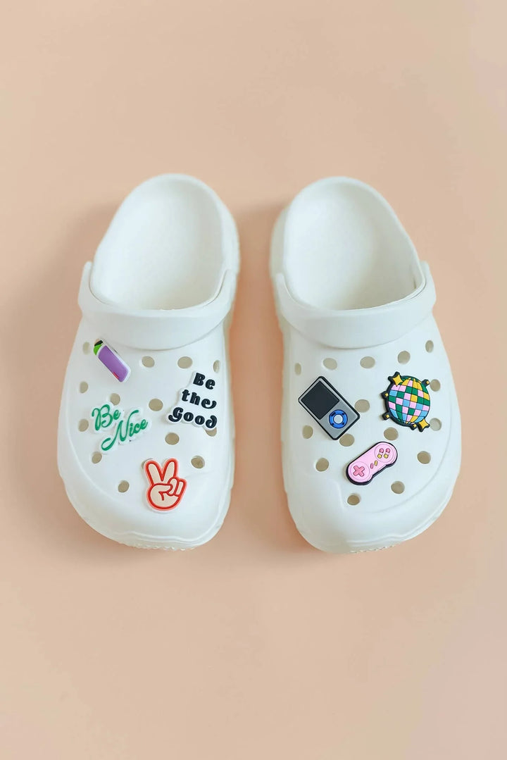 White clogs with colorful charms: peace sign, &