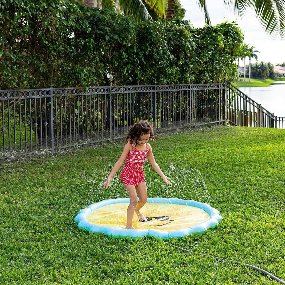 Child playing on lemon-themed splash pad in backyard, perfect for summer outdoor fun and family water play.