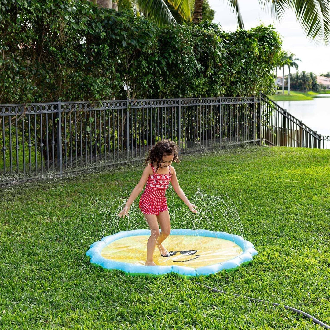 Child playing on lemon-themed splash pad in backyard, perfect for summer outdoor fun and family water play.